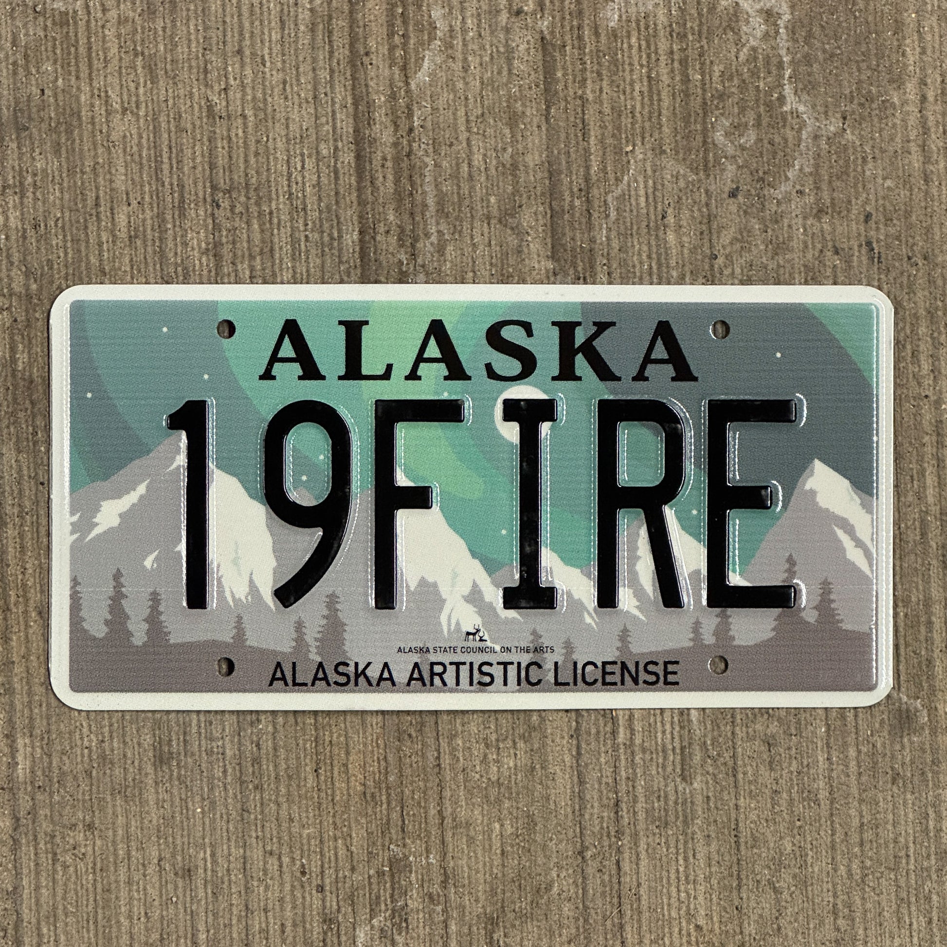 Photo of a 2019 Alaska Graphic Vanity License Plate Auto Tag 2 Vintage Garage Artistic Northern Lights Firefighter 19 FIRE with original patina