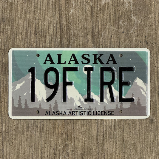 Photo of a 2019 Alaska Graphic Vanity License Plate Auto Tag 2 Vintage Garage Artistic Northern Lights Firefighter 19 FIRE with original patina