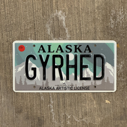 Photo of a 2019 Alaska Graphic Vanity License Plate Auto Tag 2 Vintage Garage Artistic Northern Lights Gear Head GYRHED with original patina