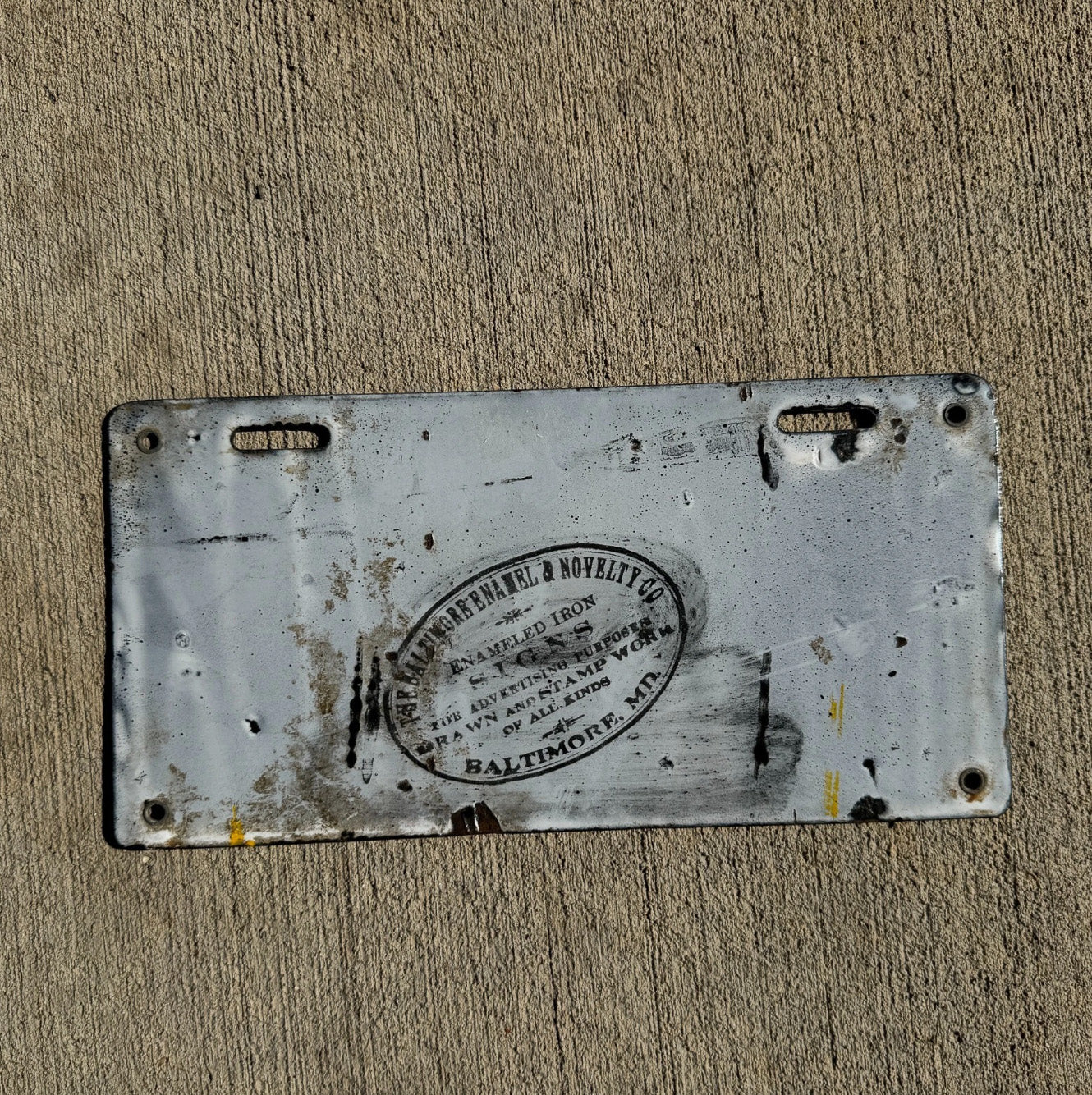 A detail view (back side) of the 1914 Delaware porcelain license plate.