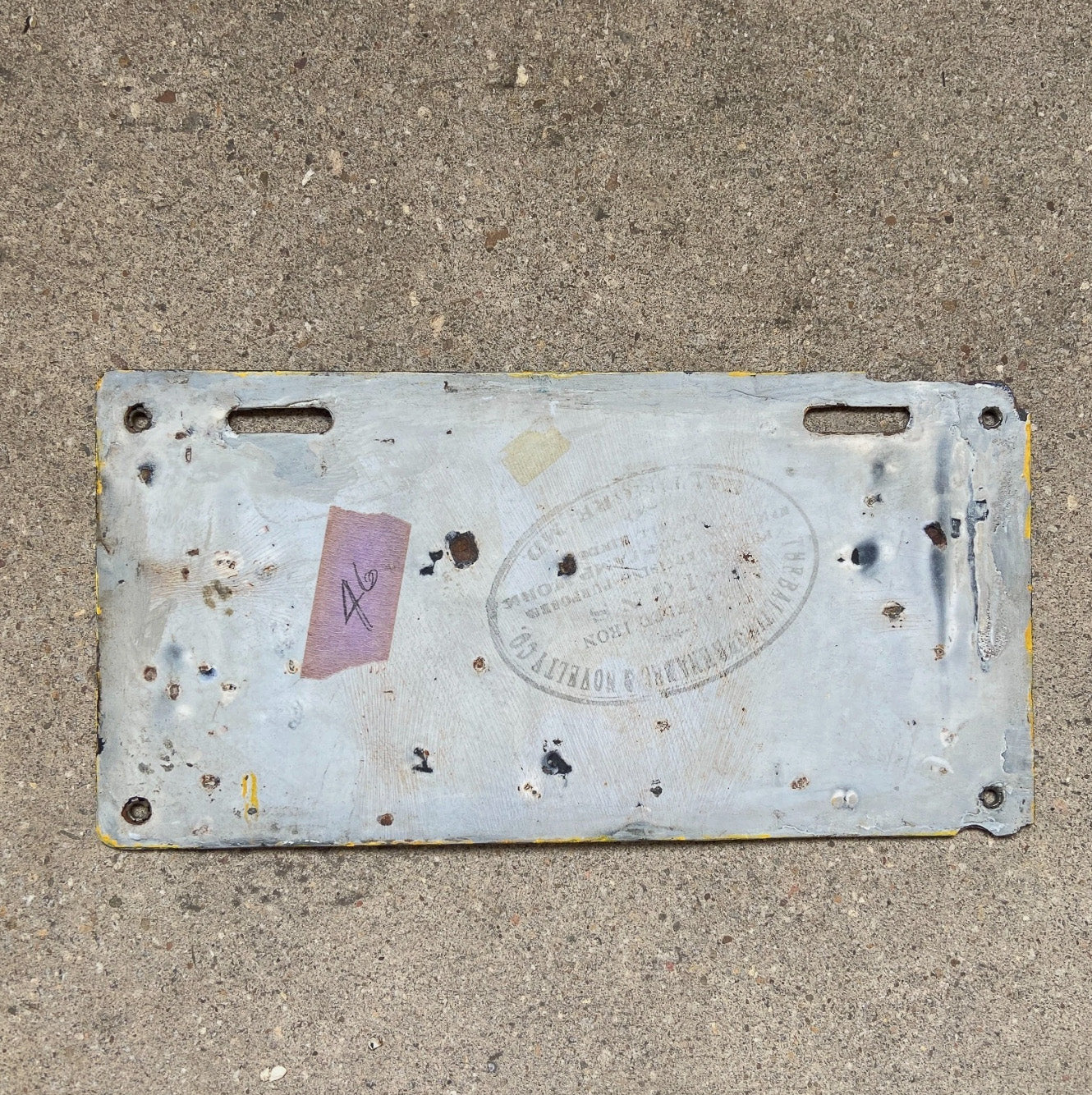 A detail view (back side) of the 1914 Delaware porcelain license plate.