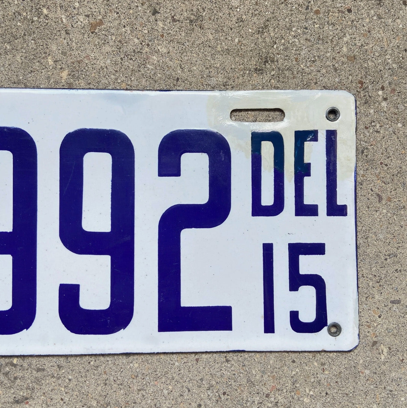 A detail view of the 1915 Delaware porcelain license plate.