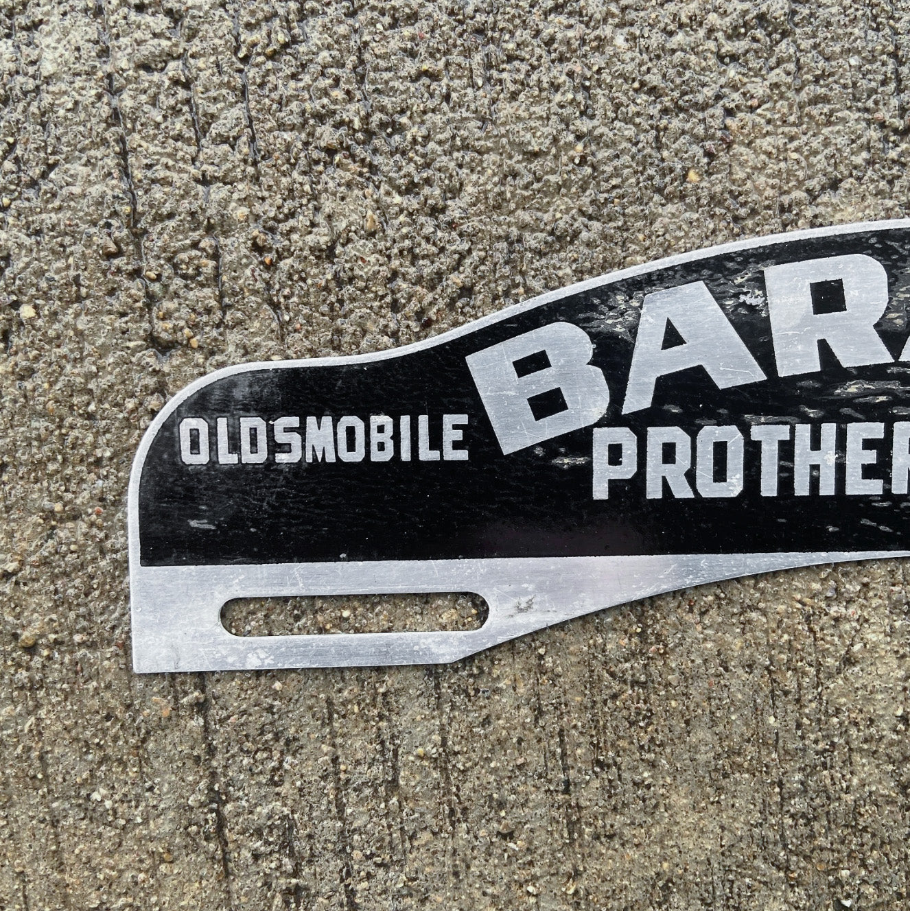 1950 Era Baraboo Wisconsin License Plate Topper Auto Tag Oldsmobile Dealer Prothero Auto