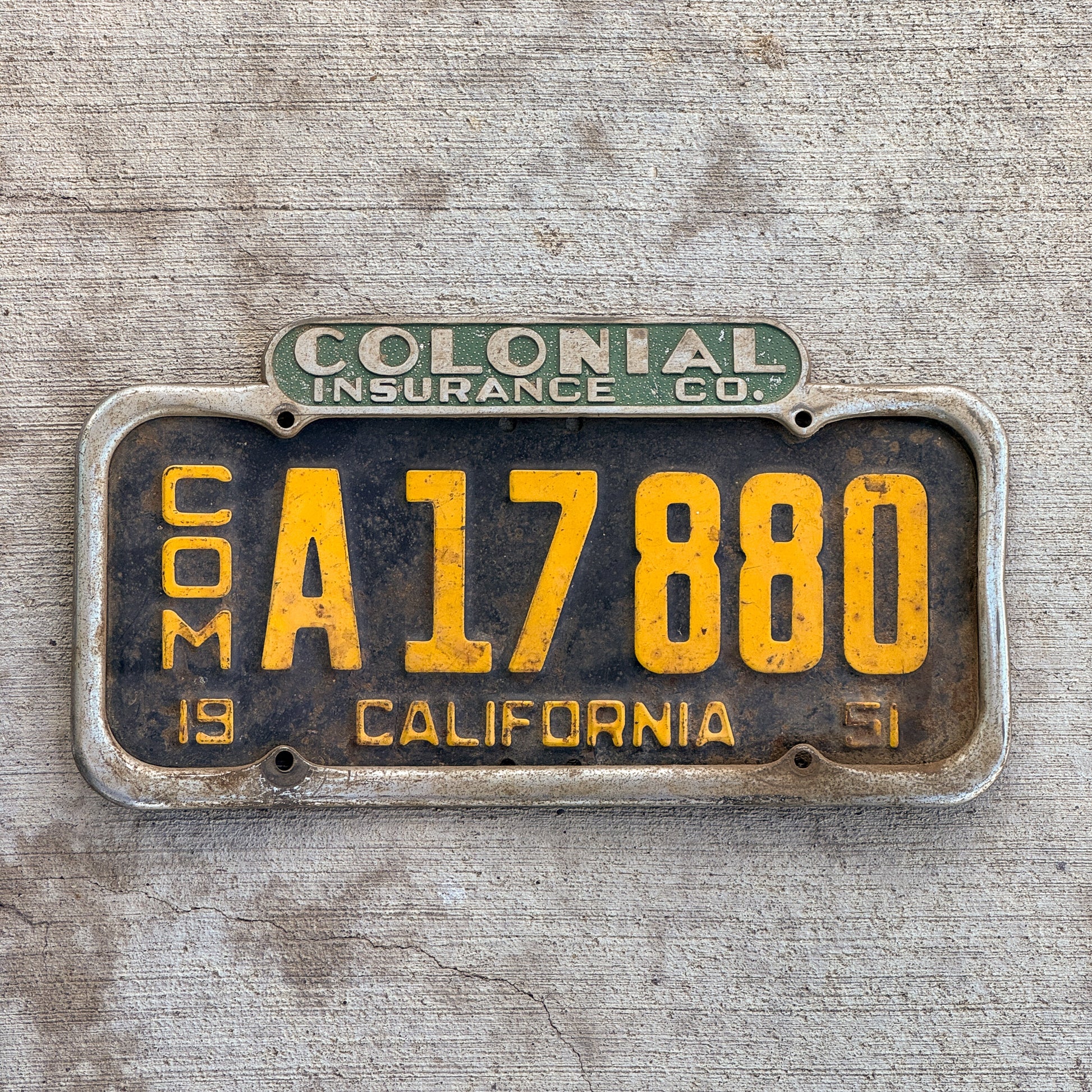 Colonial Insurance Co. license plate frame being displayed with a 1951 California commercial license plate inside.