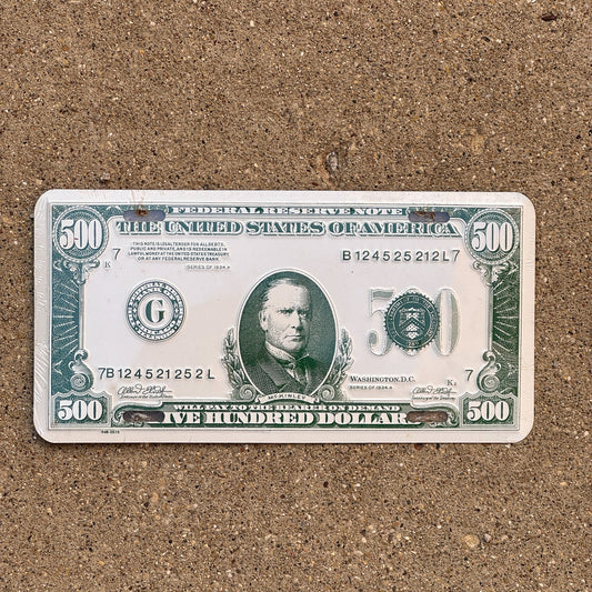 Photo of a Booster License Plate Auto Tag Garage Decor Vintage Metal 500 Dollar Money Cash