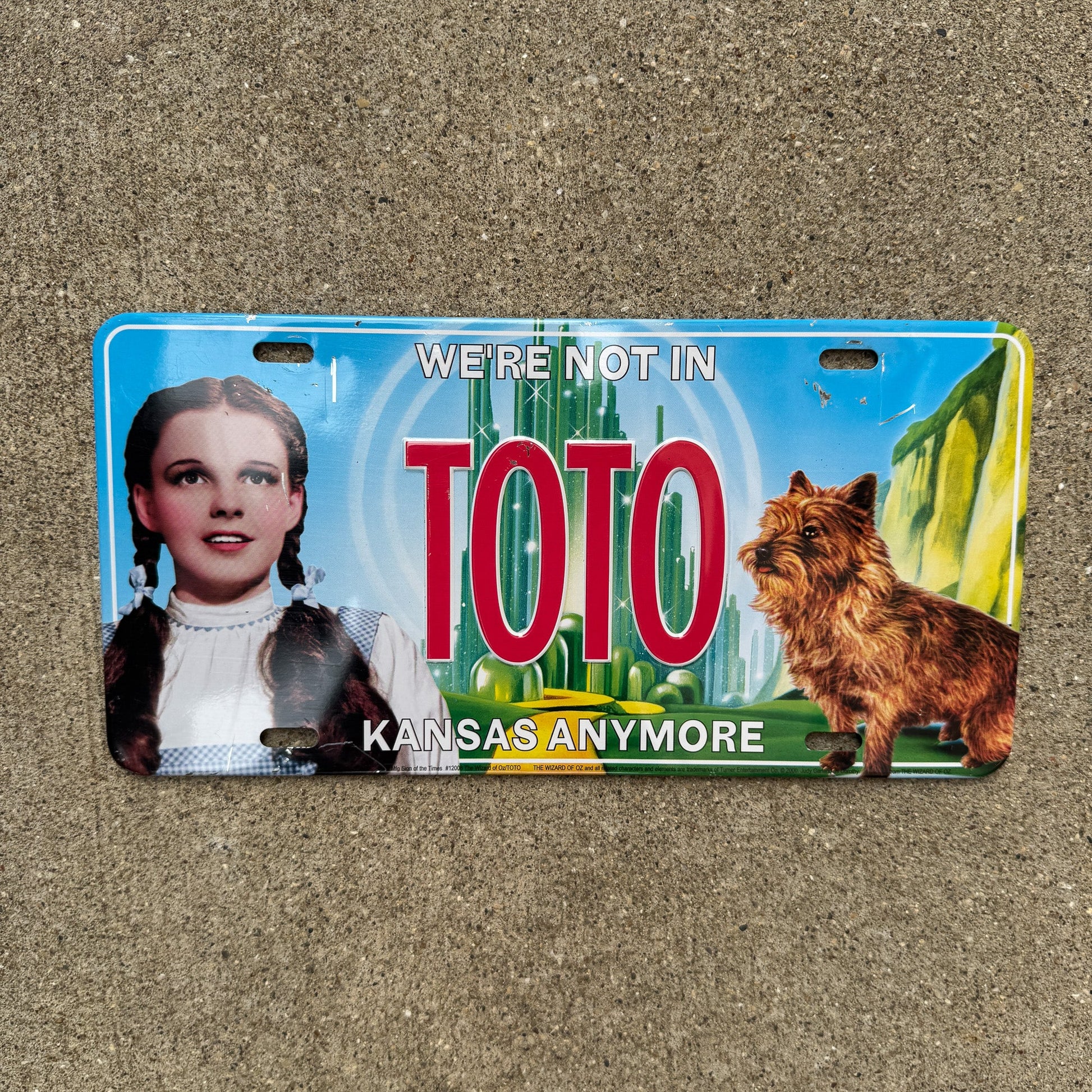 Photo of a Booster License Plate Auto Tag Garage Decor Vintage Wizard of Oz Novelty Plate TOTO