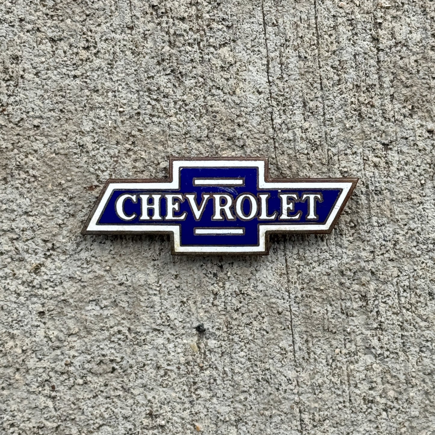 Photo of a Chevy Bowtie Porcelain Badge Emblem License Plate Topper Auto Tag Garage Decor Vintage Chevrolet with original patina