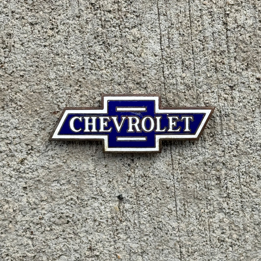 Photo of a Chevy Bowtie Porcelain Badge Emblem License Plate Topper Auto Tag Garage Decor Vintage Chevrolet with original patina