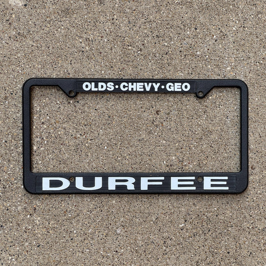 Photo of a License Plate Auto Tag Garage Decor Vintage Frame Olds Chevy Geo DURFEE Dealership