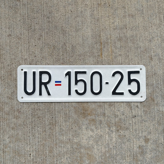 Photo of a Serbia License Plate Auto Tag Garage Decor Vintage UR 150 25 with original patina