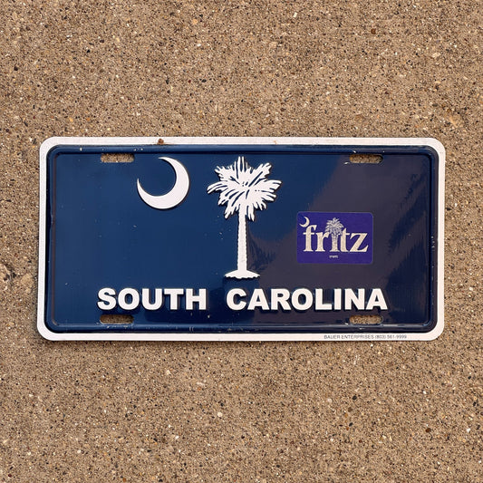 Photo of a South Carolina Booster License Plate Auto Tag Garage Decor Vintage Metal Flag Palm Tree Graphic Logo