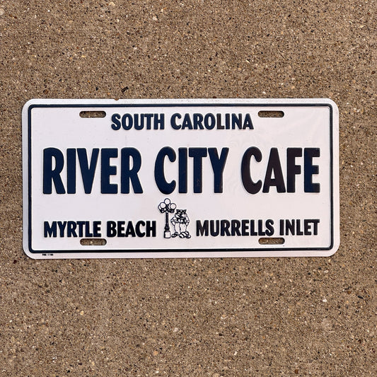 Photo of a South Carolina Booster License Plate Auto Tag Garage Decor Vintage Metal River City Café Myrtle Beach